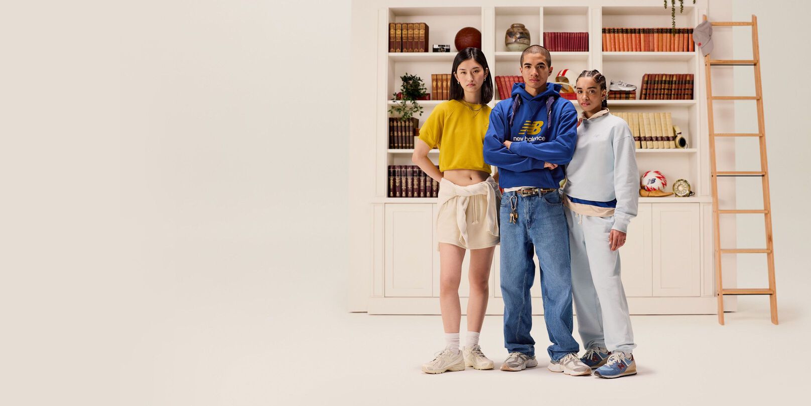 A group of people standing in front of a bookcase